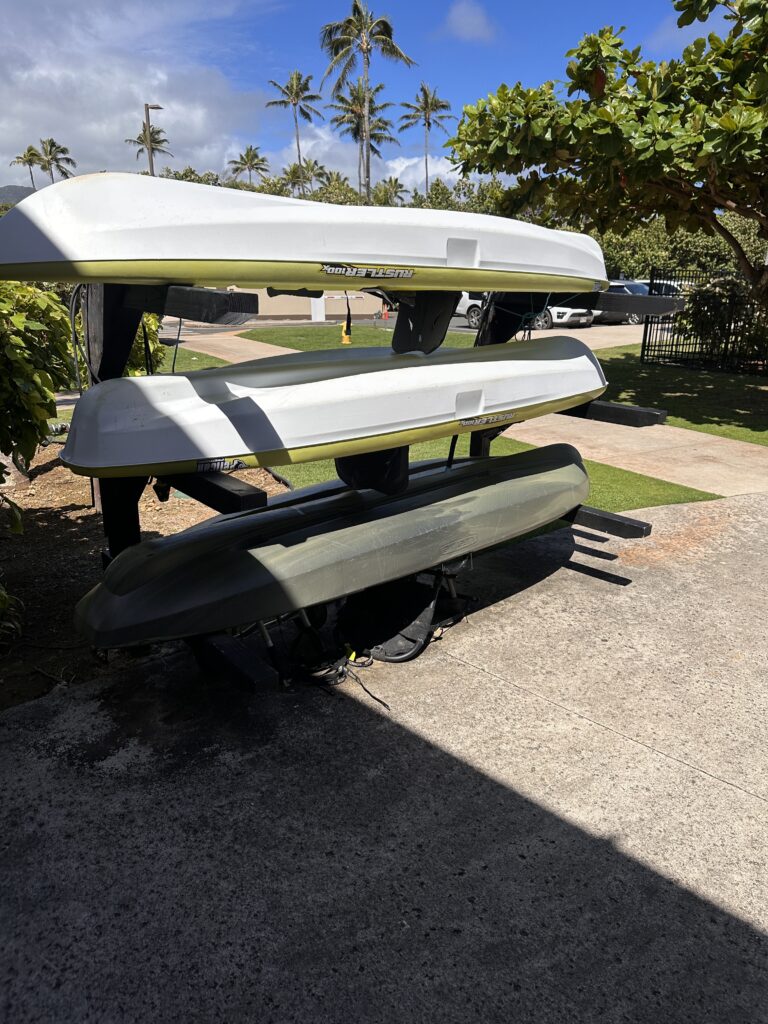 a stack of kayaks on a concrete surface