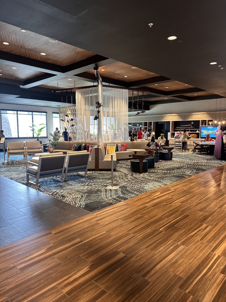 a lobby with a large chandelier and chairs