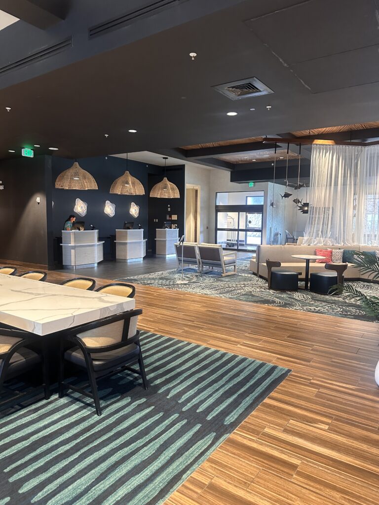 a room with a reception desk and tables