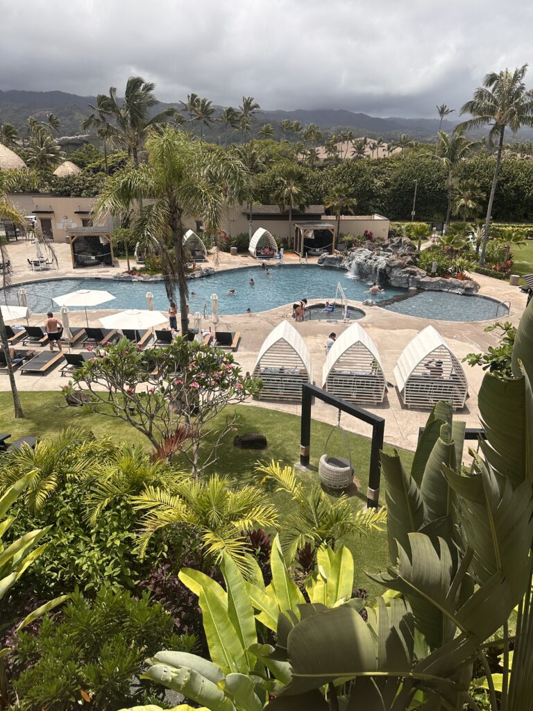 a pool with lounge chairs and trees