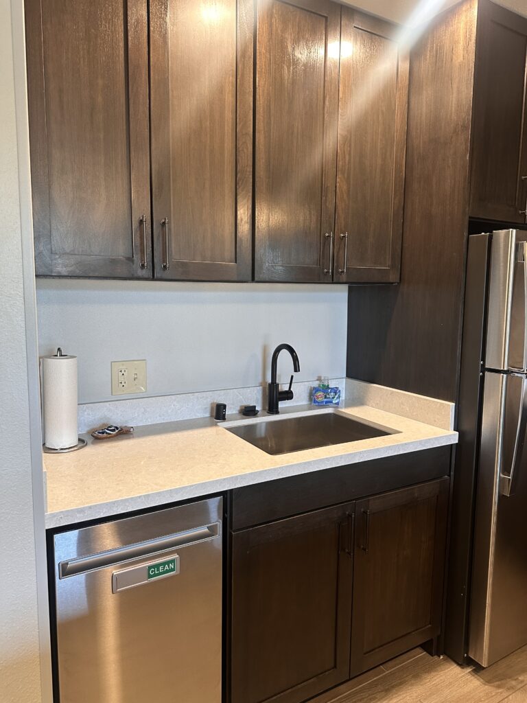 a kitchen with a sink and a refrigerator