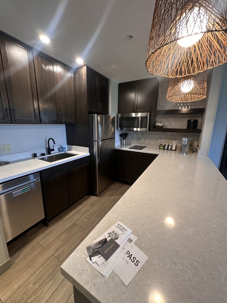 a kitchen with dark cabinets and a white counter top