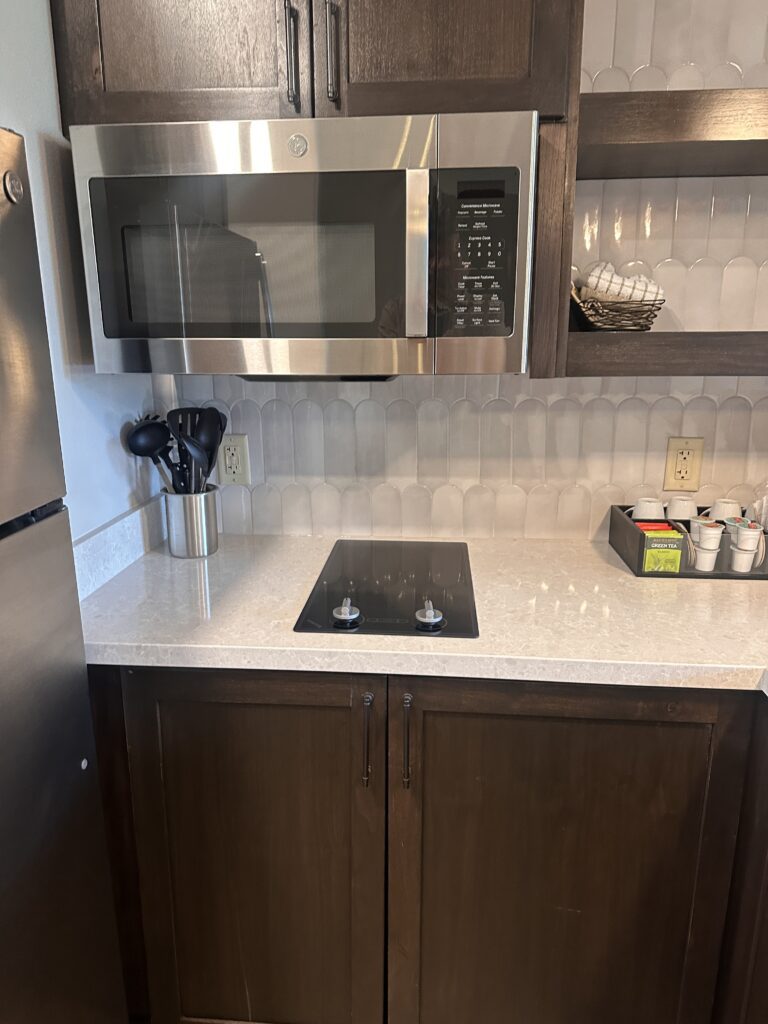a kitchen with a microwave oven and a stainless steel stove