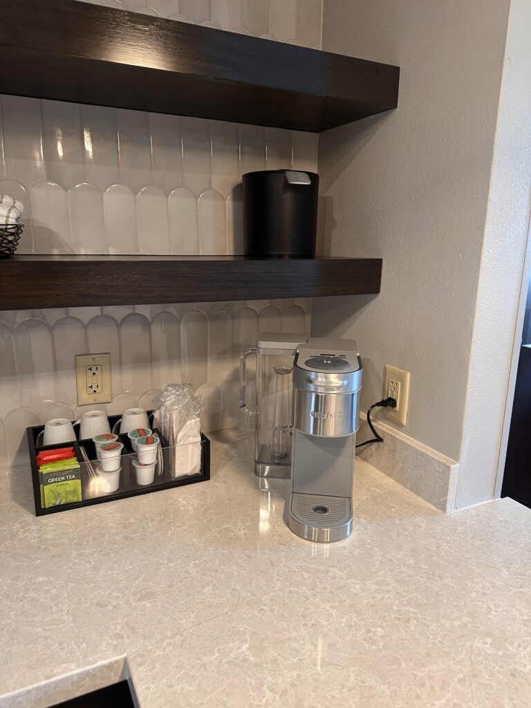 a coffee maker and coffee mugs on a counter