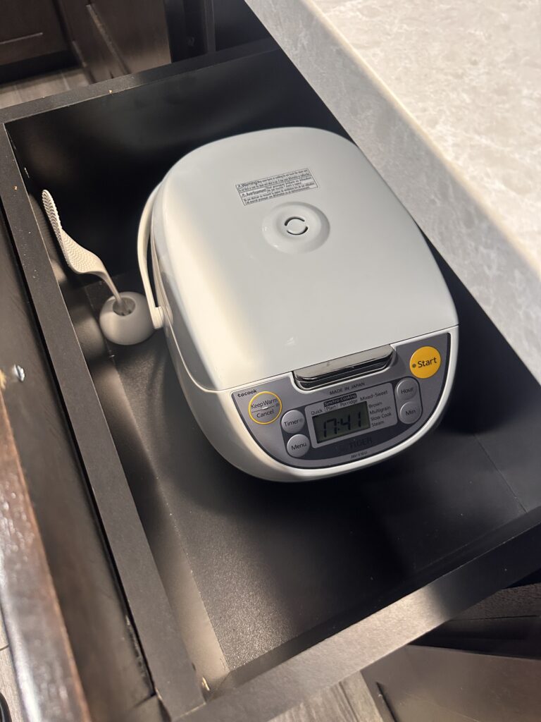 a white electronic device in a drawer