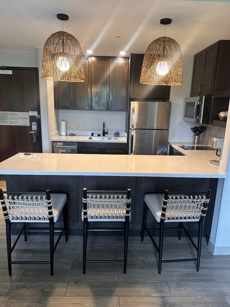 a kitchen with a bar and stools