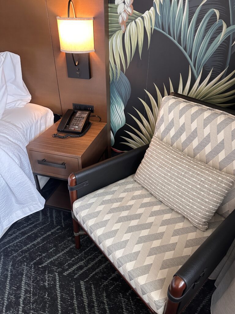 a chair next to a bed