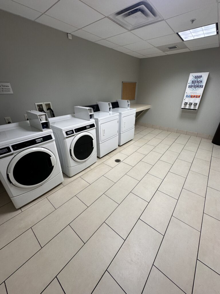 a room with washing machines and dryers