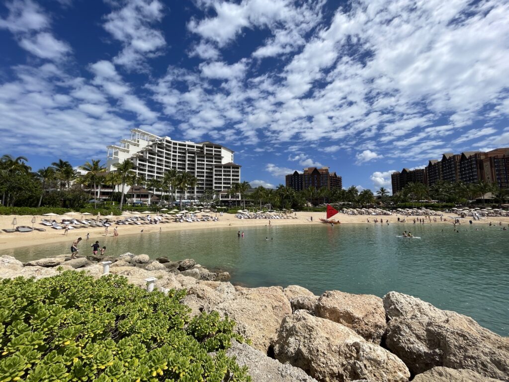 Where to Stay on O'ahu: Comparing Waikīkī, Ko Olina, and the North Shore Hawaii Calling a beach with rocks and a building in the background