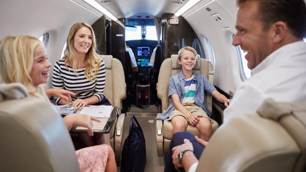 Free Flights from Honolulu to Lānaʻi with Four Seasons Resort Bookings Through 2026 Hawaii Calling a group of people sitting in chairs in an airplane