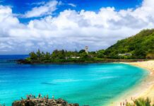 Best Time to Visit O‘ahu: Weather, Crowds & Culture a beach with rocks and trees