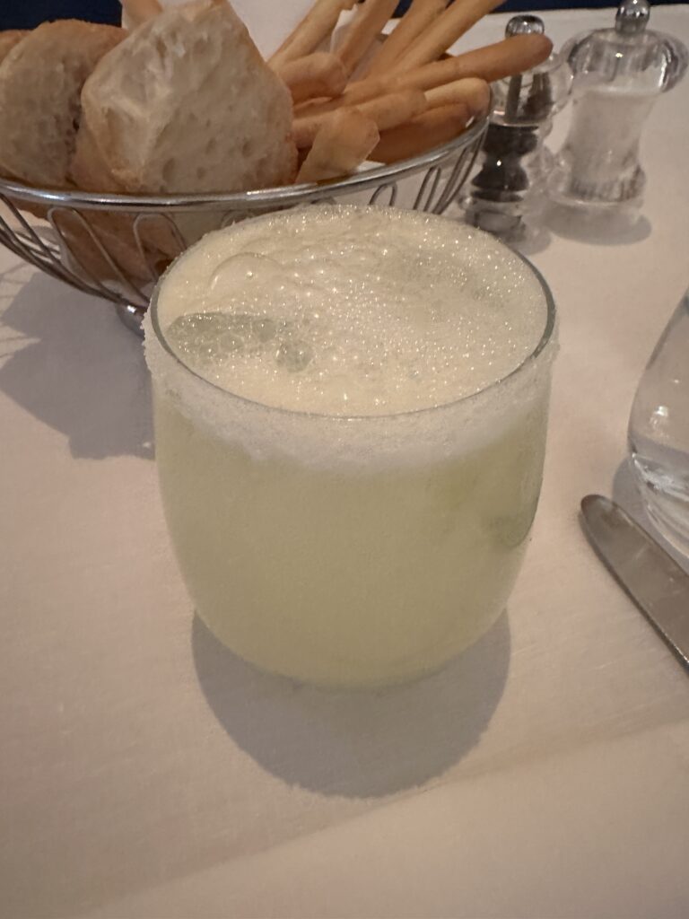 a glass of liquid on a table