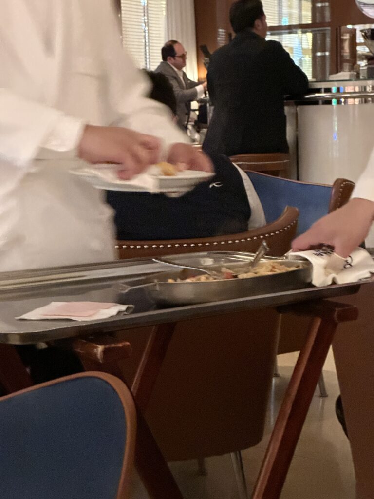 a person in a white coat serving food