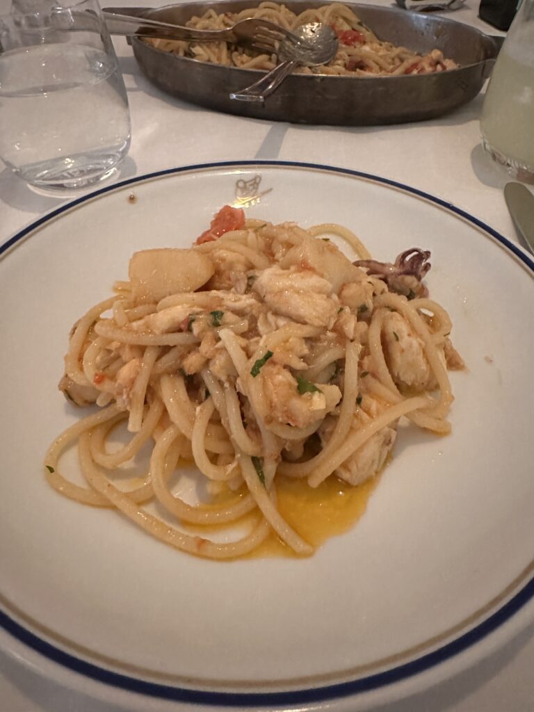 a plate of pasta with seafood on it