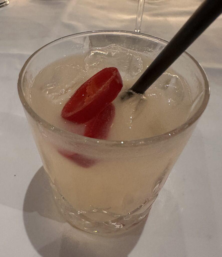 a glass with a drink and a spoon